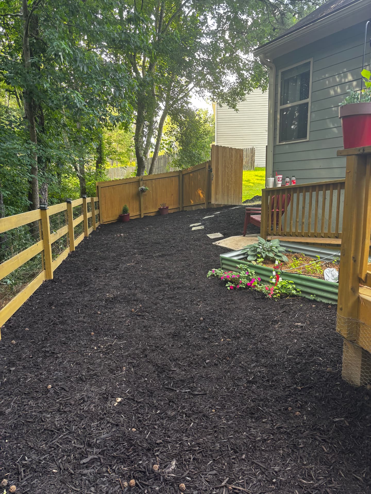 Crew member edging a lawn along a driveway